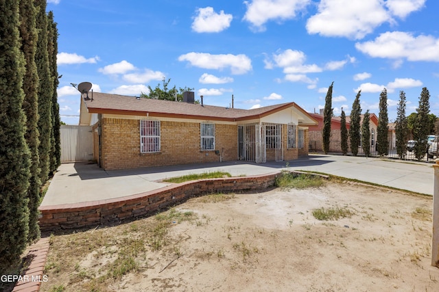 9232 Morelia Rd, El Paso, TX 79907 - rear view of house with a patio, brick siding, and fence