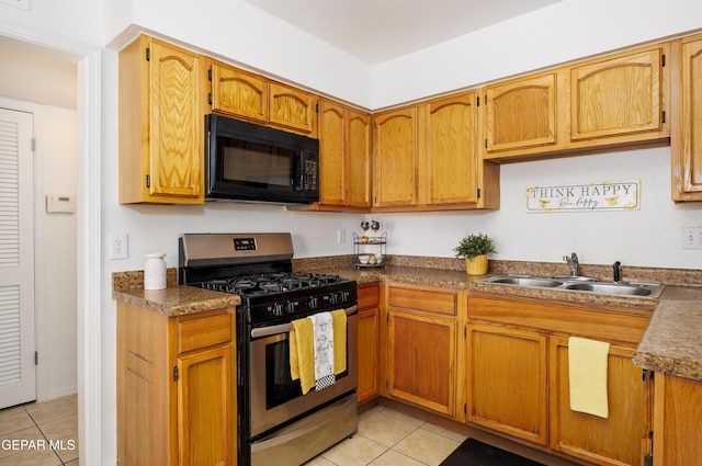 9232 Morelia Rd, El Paso, TX 79907 - kitchen with a sink, stainless steel gas range oven, black microwave, and light tile patterned floors
