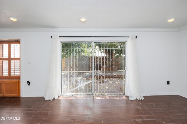 9232 Morelia Rd, El Paso, TX 79907 - spare room featuring crown molding, baseboards, and wood tiled floor