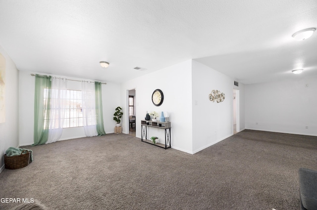 9232 Morelia Rd, El Paso, TX 79907 - unfurnished living room with carpet flooring, baseboards, and visible vents