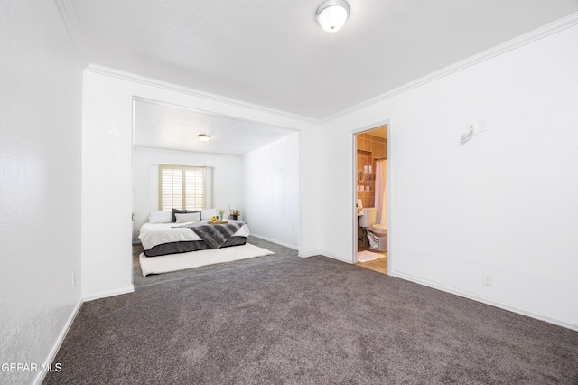 9232 Morelia Rd, El Paso, TX 79907 - carpeted bedroom with crown molding, ensuite bathroom, and baseboards