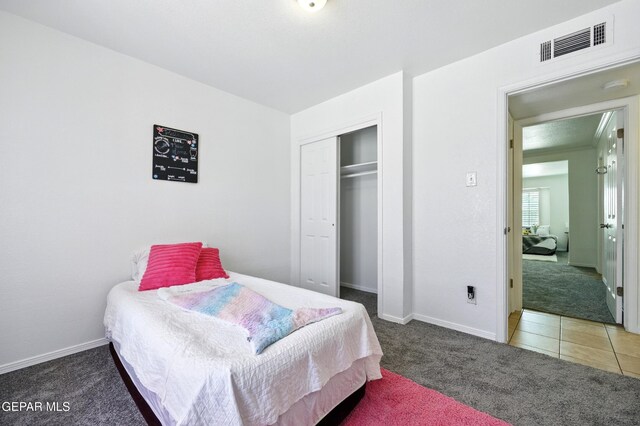 9232 Morelia Rd, El Paso, TX 79907 - carpeted bedroom with baseboards, a closet, and visible vents