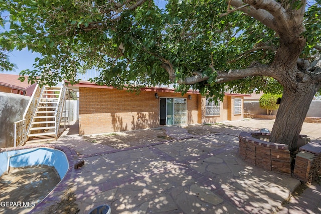 9232 Morelia Rd, El Paso, TX 79907 - ranch-style home featuring a patio area, stairs, fence, and brick siding