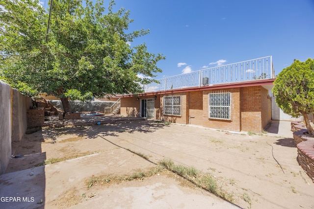 9232 Morelia Rd, El Paso, TX 79907 - back of house featuring brick siding, fence, and a patio