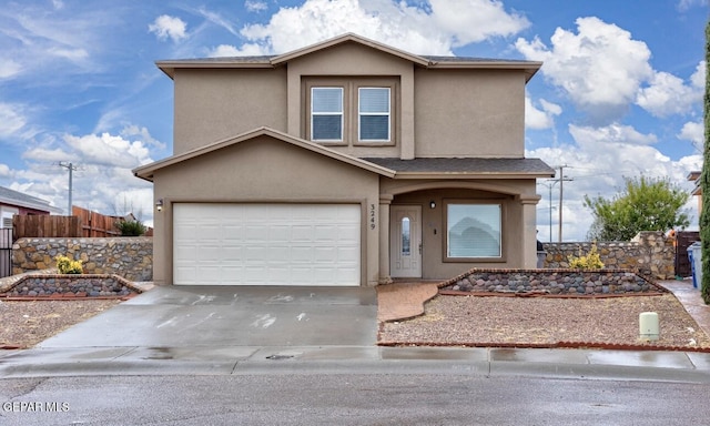 traditional-style home with an attached garage, stucco siding, driveway, and fence