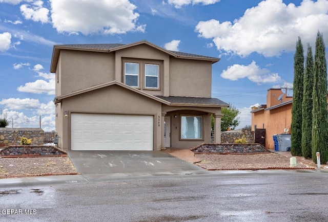 traditional-style house with an attached garage, stucco siding, and concrete driveway