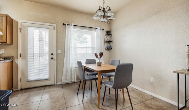 dining room featuring an inviting chandelier, baseboards, and light tile patterned floors