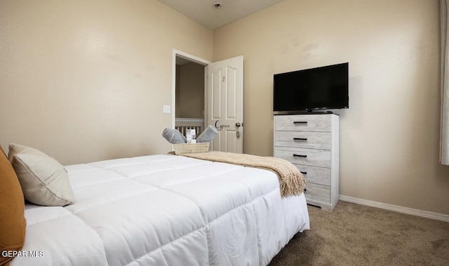 bedroom with baseboards and light colored carpet