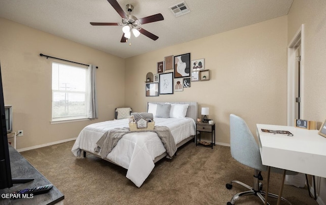 carpeted bedroom featuring a ceiling fan, baseboards, visible vents, and a textured ceiling