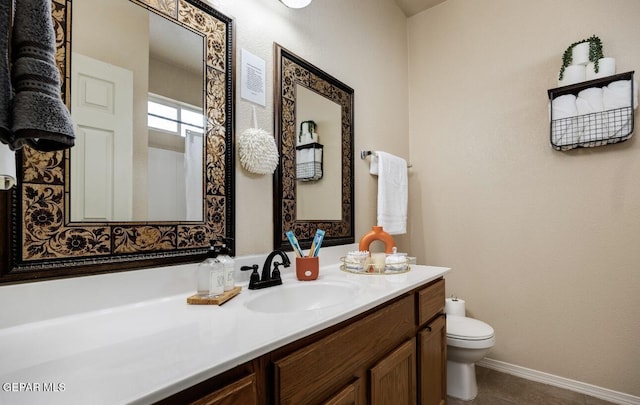 bathroom featuring vanity, baseboards, toilet, and visible vents