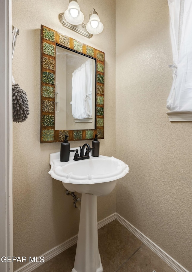 bathroom featuring baseboards and tile patterned flooring