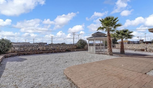 view of patio with a gazebo and fence