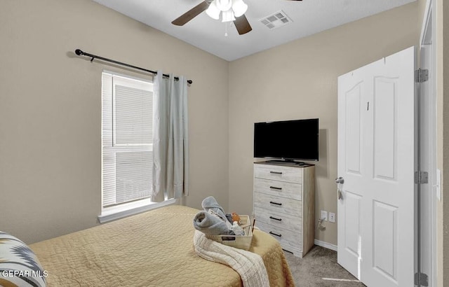 carpeted bedroom with a ceiling fan and visible vents