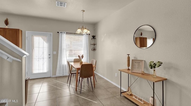 dining space featuring light tile patterned floors, baseboards, an inviting chandelier, and visible vents