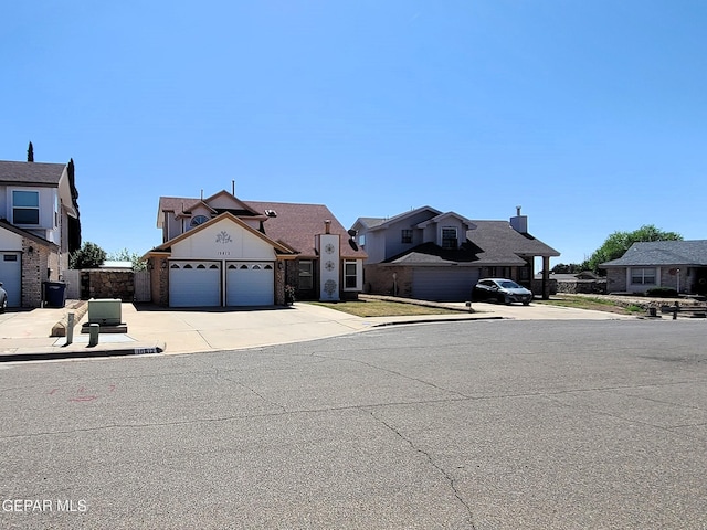 10812 Sandy Koufax Dr, El Paso, TX 79924 - exterior space featuring an attached garage, driveway, and a residential view