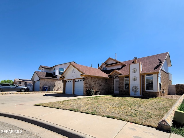 10812 Sandy Koufax Dr, El Paso, TX 79924 - view of front facade with concrete driveway, brick siding, an attached garage, and a front yard