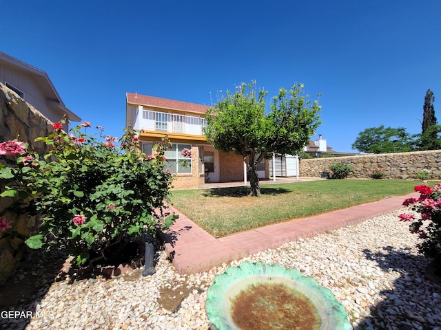 10812 Sandy Koufax Dr, El Paso, TX 79924 - rear view of house featuring a yard and brick siding