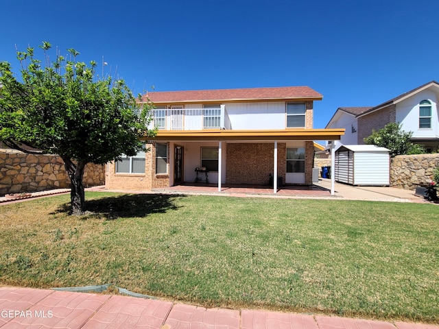 10812 Sandy Koufax Dr, El Paso, TX 79924 - rear view of house with an outdoor structure, a shed, brick siding, a patio area, and a lawn