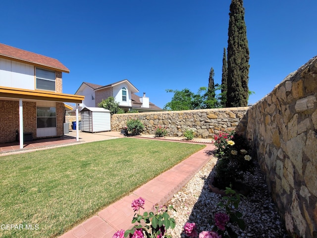 10812 Sandy Koufax Dr, El Paso, TX 79924 - view of yard with a patio, an outdoor structure, a fenced backyard, and a storage unit