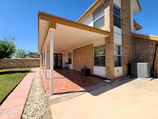 10812 Sandy Koufax Dr, El Paso, TX 79924 - rear view of property featuring french doors, a patio, cooling unit, and brick siding