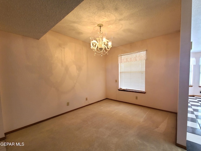 10812 Sandy Koufax Dr, El Paso, TX 79924 - empty room featuring baseboards, carpet, a textured ceiling, and a chandelier