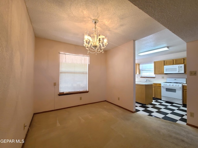 10812 Sandy Koufax Dr, El Paso, TX 79924 - kitchen featuring light countertops, a textured ceiling, a chandelier, and white appliances