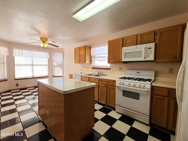 10812 Sandy Koufax Dr, El Paso, TX 79924 - kitchen featuring a sink, light floors, white appliances, and light countertops