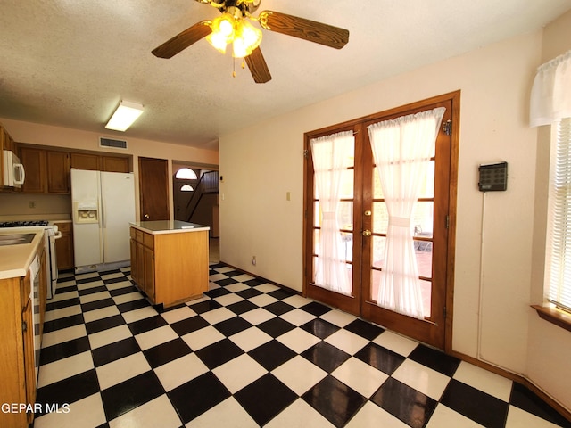 10812 Sandy Koufax Dr, El Paso, TX 79924 - kitchen with french doors, visible vents, light countertops, light floors, and white appliances