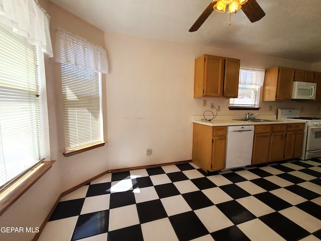 10812 Sandy Koufax Dr, El Paso, TX 79924 - kitchen with a ceiling fan, white appliances, light floors, light countertops, and a sink