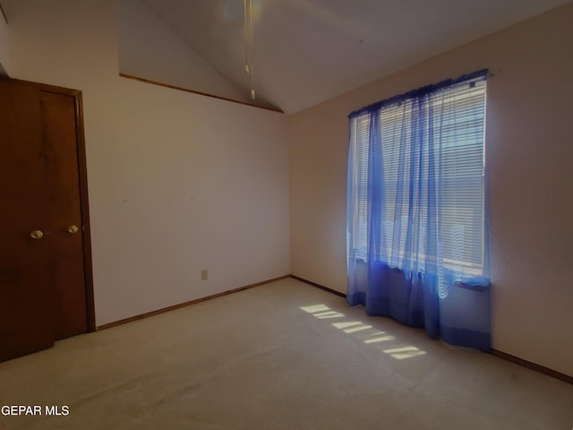 10812 Sandy Koufax Dr, El Paso, TX 79924 - empty room featuring baseboards, vaulted ceiling, and light colored carpet