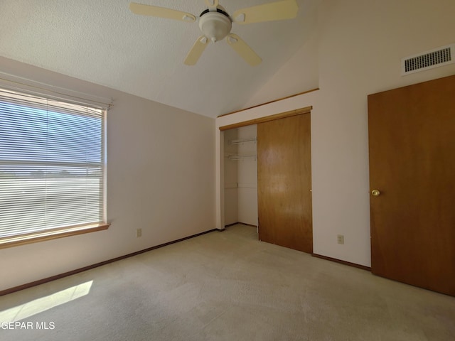 10812 Sandy Koufax Dr, El Paso, TX 79924 - unfurnished bedroom with visible vents, a closet, baseboards, light colored carpet, and vaulted ceiling
