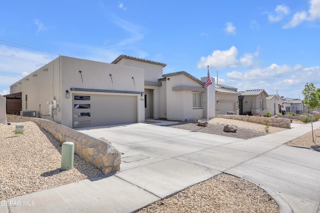 view of front of property featuring central AC, stucco siding, concrete driveway, an attached garage, and a residential view