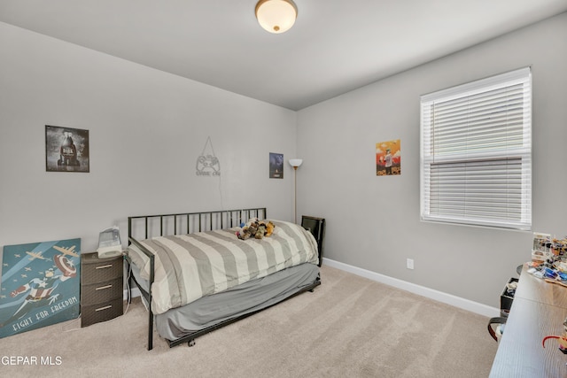 bedroom with carpet floors and baseboards