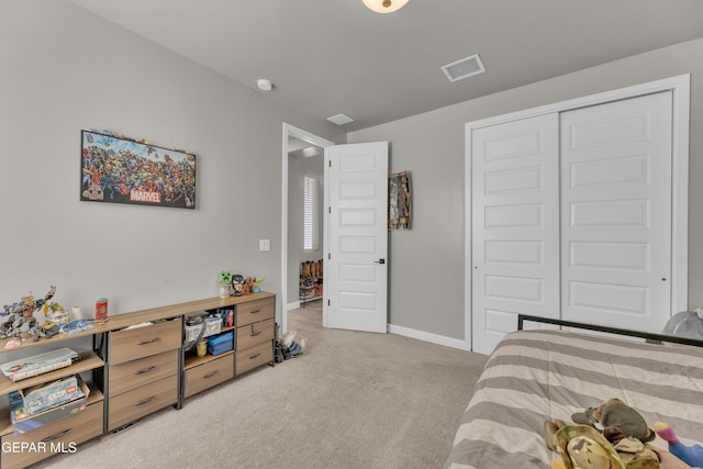 bedroom featuring light colored carpet, baseboards, visible vents, and a closet
