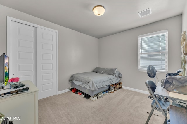 carpeted bedroom featuring visible vents and baseboards