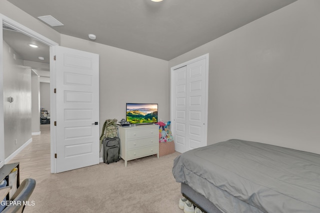 bedroom featuring baseboards and light colored carpet