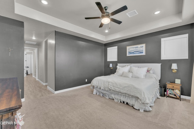 carpeted bedroom featuring recessed lighting, baseboards, ceiling fan, and a raised ceiling