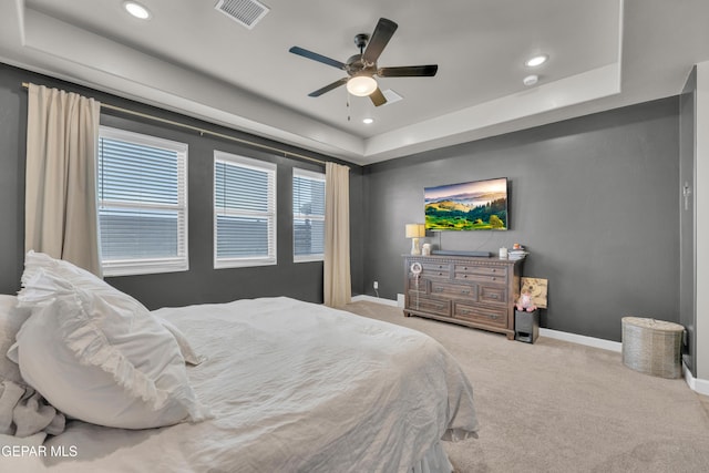 bedroom featuring a raised ceiling, carpet, recessed lighting, baseboards, and visible vents