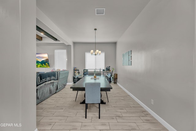 dining space with visible vents, wood tiled floor, baseboards, and a notable chandelier