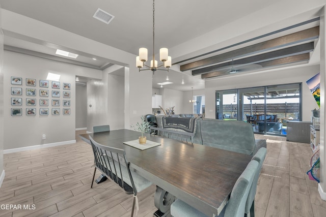 dining space with baseboards, wood tiled floor, beam ceiling, and visible vents