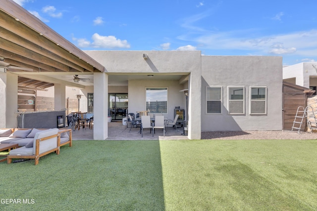 back of house with a lawn, ceiling fan, a patio area, and stucco siding