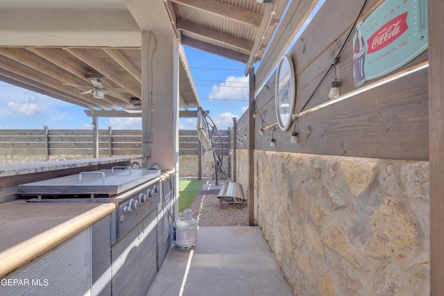 view of patio with ceiling fan and fence