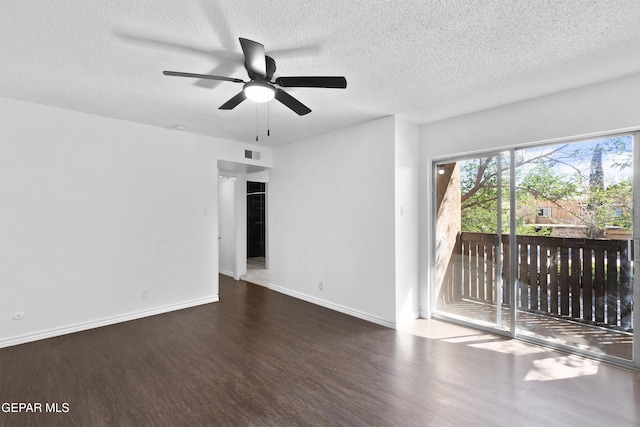 spare room featuring baseboards, a ceiling fan, a textured ceiling, and wood finished floors