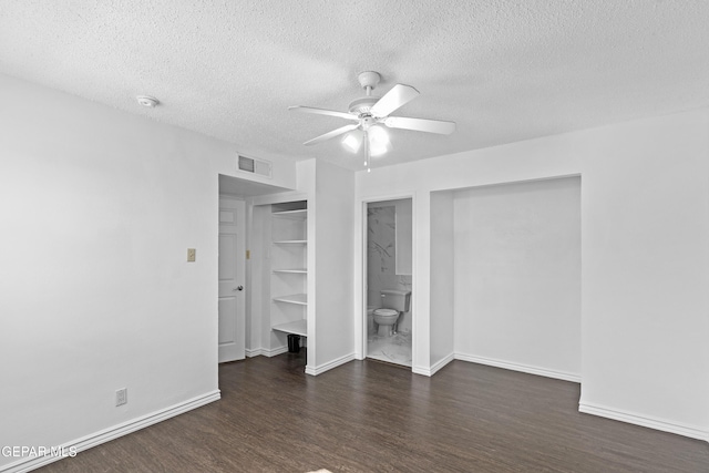 unfurnished bedroom featuring a textured ceiling, visible vents, and wood finished floors