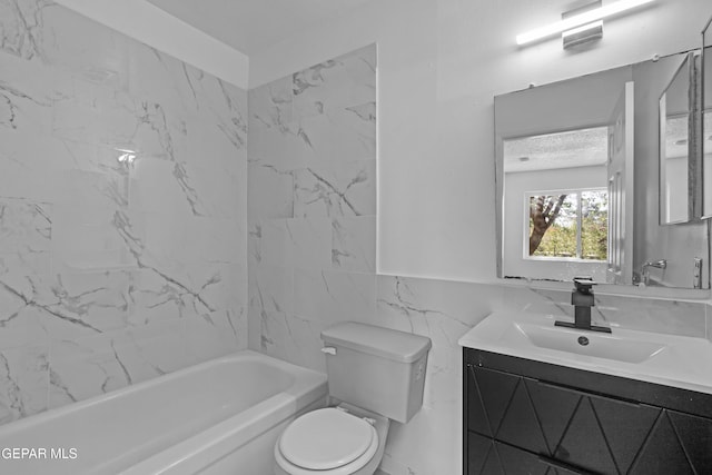 bathroom with toilet, tile walls, bathing tub / shower combination, and vanity