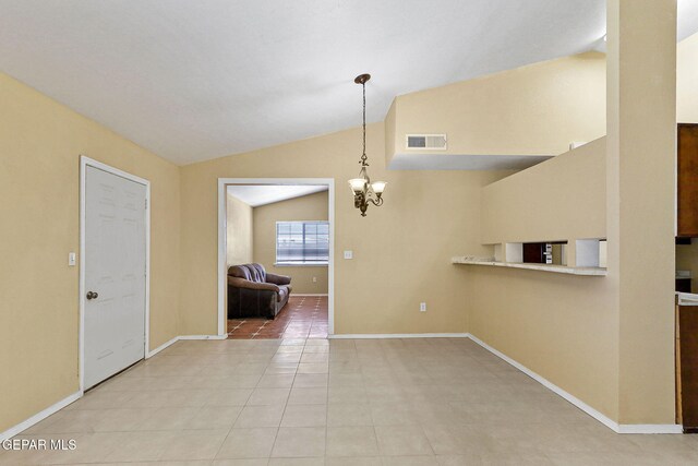 spare room featuring a notable chandelier, baseboards, light tile patterned floors, lofted ceiling, and visible vents