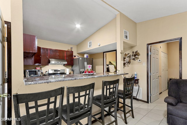 kitchen featuring visible vents, light tile patterned floors, under cabinet range hood, and stainless steel appliances