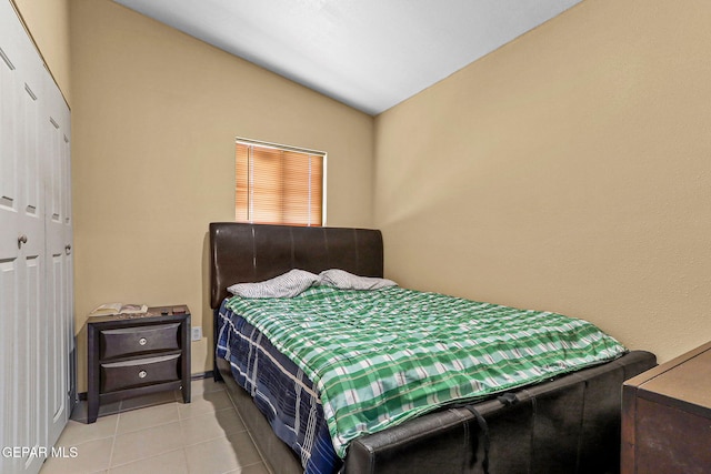 bedroom featuring tile patterned floors and lofted ceiling