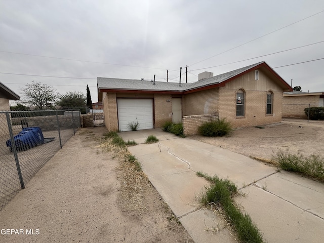 9121 Jalapa Dr, El Paso, TX 79907 - single story home with brick siding, a garage, fence, and driveway