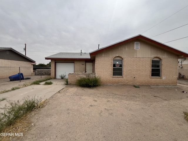9121 Jalapa Dr, El Paso, TX 79907 - view of front of home featuring brick siding, a garage, fence, and concrete driveway